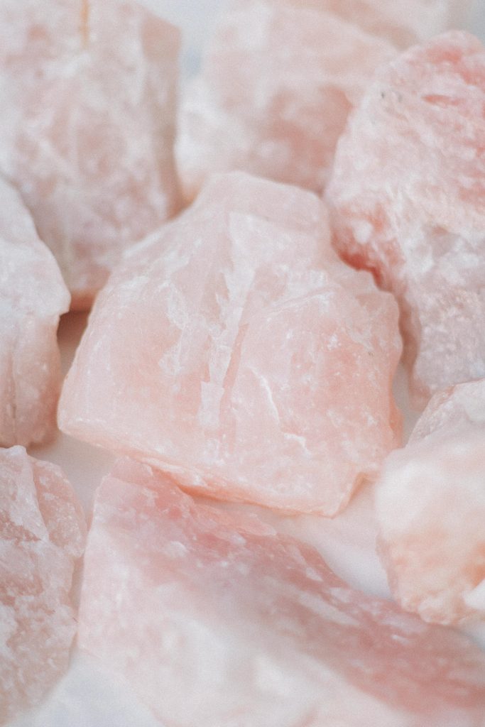 Detailed image of raw rose quartz crystals, showcasing their unique textures and healing properties.