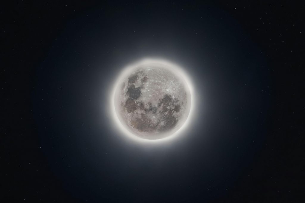 A stunning full moon with glowing edges against a backdrop of stars in the night sky. Perfect for astronomy enthusiasts.
