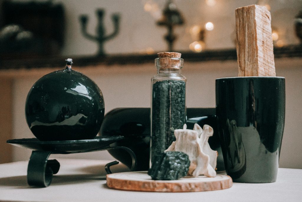 Collection of magic items with timber round shaped board with granite stone on blurred background